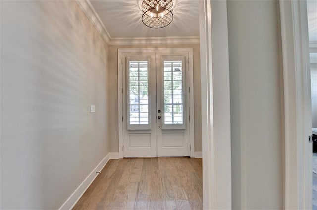 doorway to outside with crown molding, baseboards, french doors, and wood finished floors