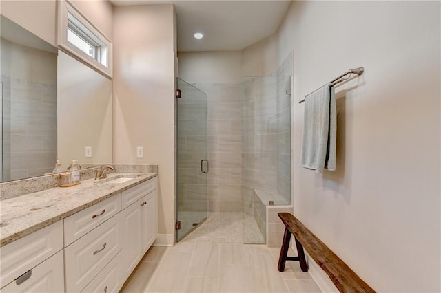 full bathroom featuring vanity, tile patterned flooring, a stall shower, and recessed lighting