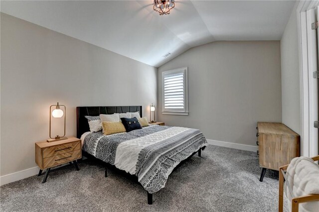 bedroom featuring carpet flooring, baseboards, and lofted ceiling