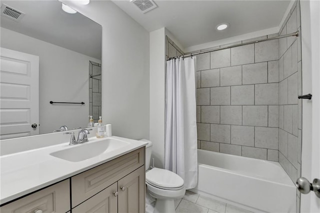 bathroom featuring visible vents, tile patterned flooring, toilet, and vanity