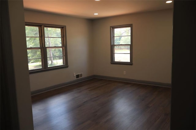 spare room with dark hardwood / wood-style flooring