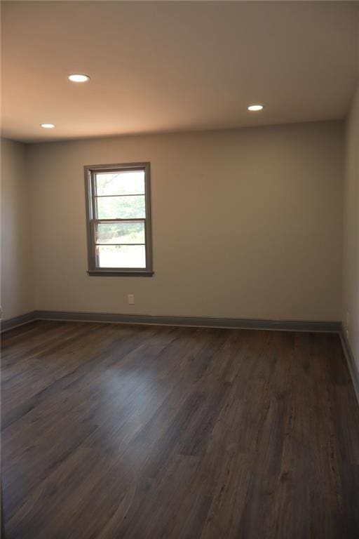 empty room with dark wood-type flooring