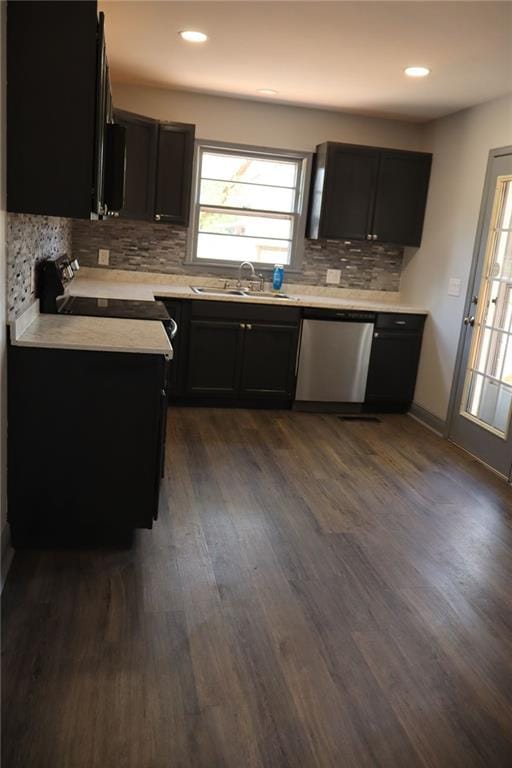 kitchen featuring dark hardwood / wood-style flooring, backsplash, stainless steel dishwasher, electric range oven, and sink