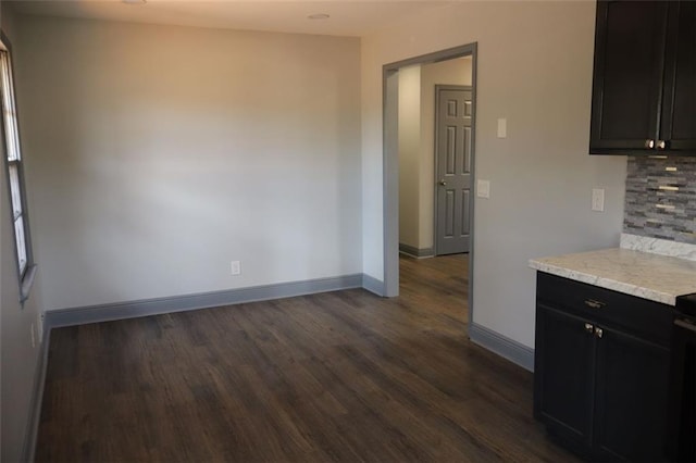 kitchen featuring dark wood-type flooring and tasteful backsplash