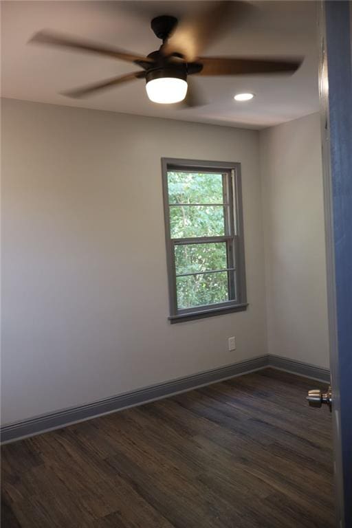 spare room featuring ceiling fan and dark hardwood / wood-style floors