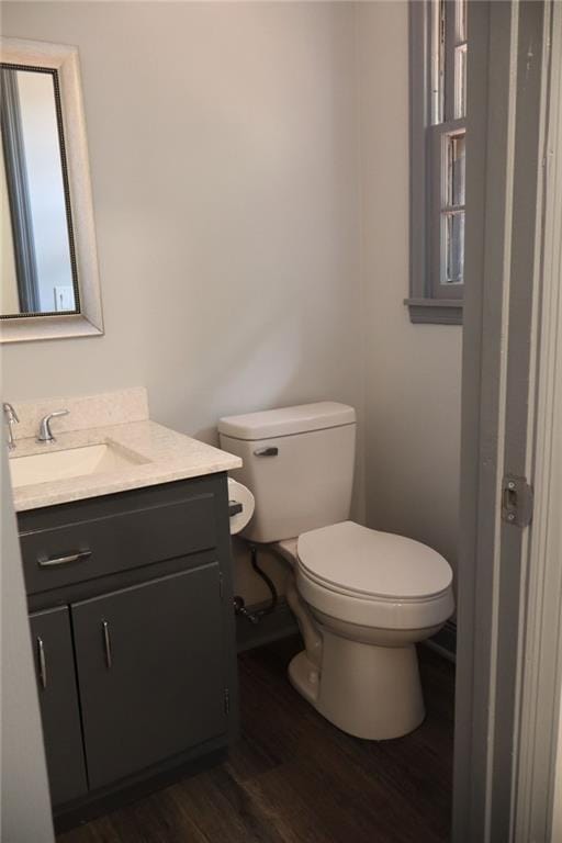 bathroom featuring vanity, toilet, and hardwood / wood-style floors