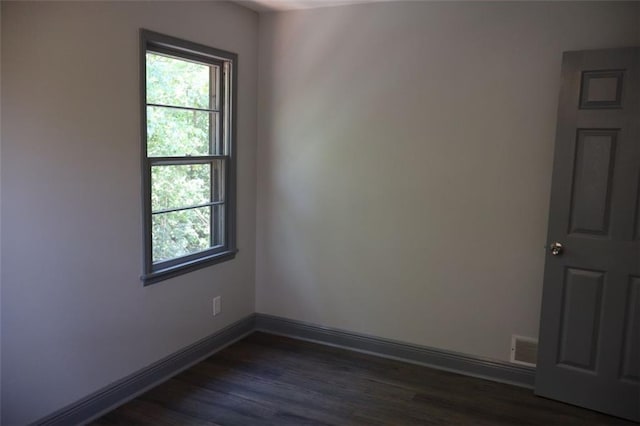 spare room with dark hardwood / wood-style floors