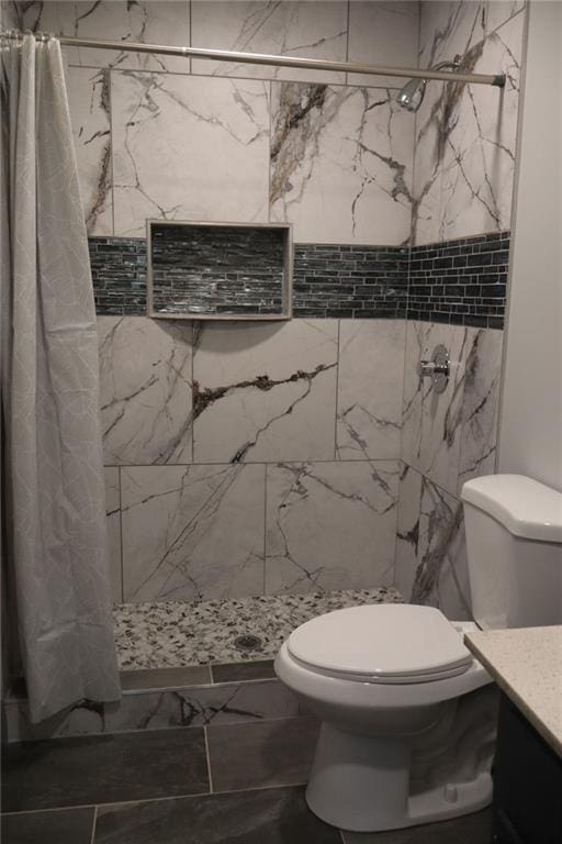 bathroom with vanity, toilet, and curtained shower