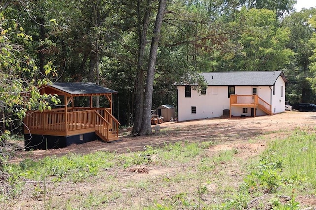 back of property featuring a gazebo