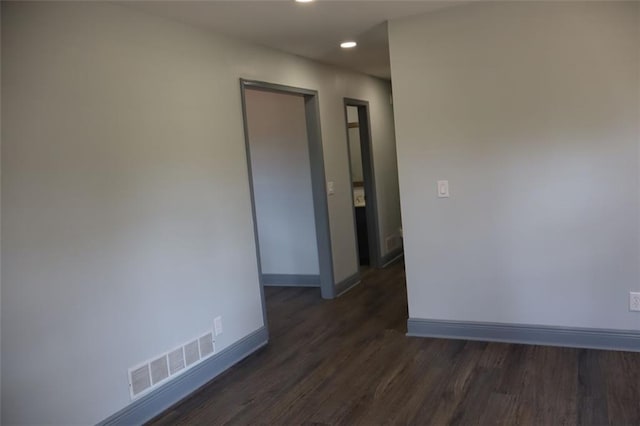 unfurnished room with dark hardwood / wood-style floors