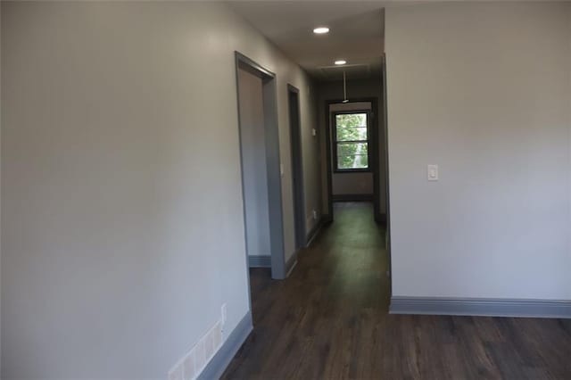 hallway with dark hardwood / wood-style flooring