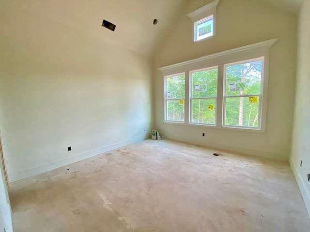 LOT35 Waterview Ct, Newnan, GA 30263 - empty room with high vaulted ceiling, concrete flooring, and baseboards
