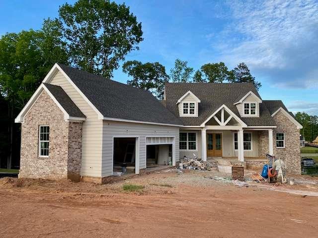 LOT35 Waterview Ct, Newnan, GA 30263 - view of front facade with an attached garage, covered porch, and dirt driveway