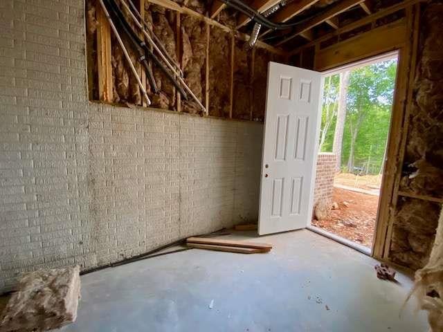 LOT35 Waterview Ct, Newnan, GA 30263 - miscellaneous room featuring unfinished concrete flooring and brick wall