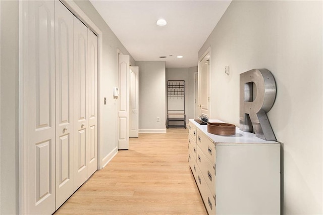 hall featuring recessed lighting, baseboards, and light wood finished floors