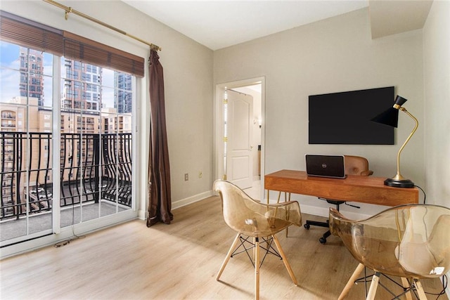 office with baseboards and wood finished floors