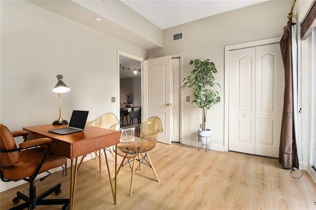 home office with baseboards, visible vents, and light wood-style flooring