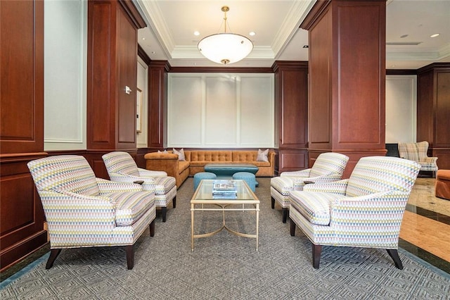 living area featuring recessed lighting, ornamental molding, and a decorative wall