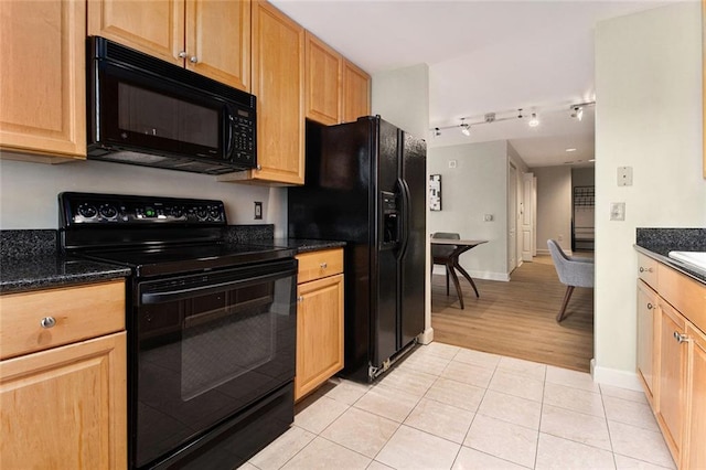 kitchen with baseboards, black appliances, rail lighting, and light tile patterned flooring