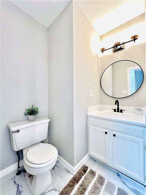 bathroom featuring toilet and vanity