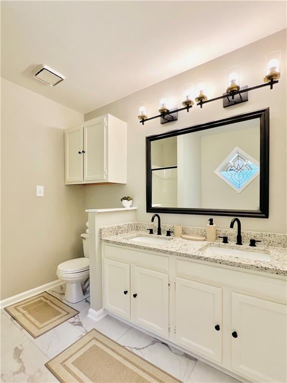 bathroom featuring vanity and toilet