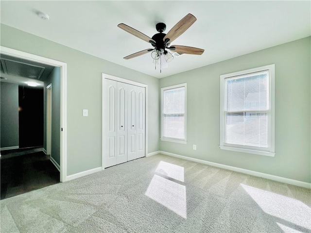 unfurnished bedroom with a closet, ceiling fan, and light colored carpet