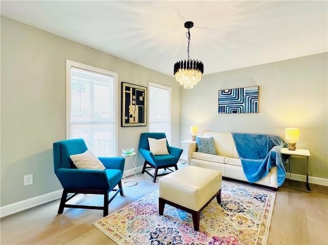 living room featuring light hardwood / wood-style floors and a notable chandelier