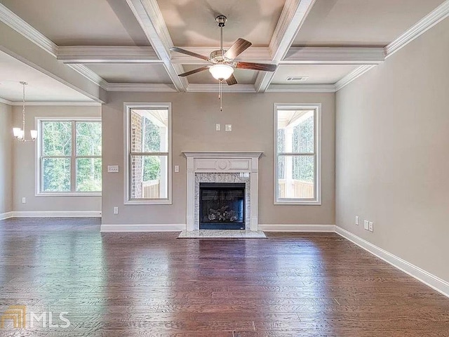 unfurnished living room featuring dark wood-style floors, plenty of natural light, and baseboards