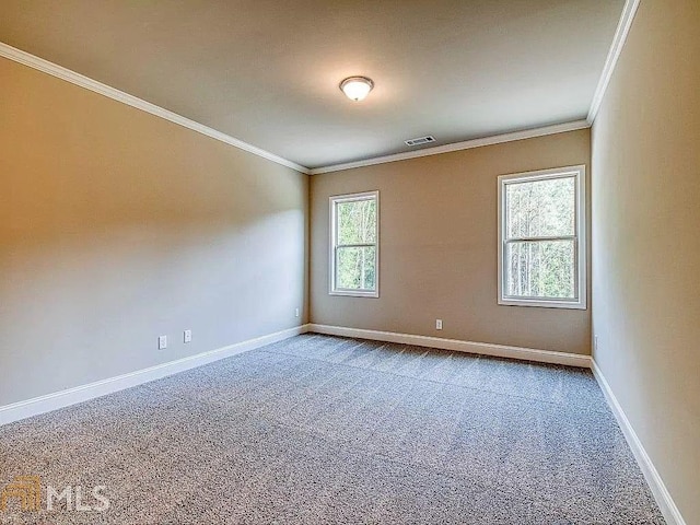 unfurnished room with crown molding, carpet, visible vents, and baseboards