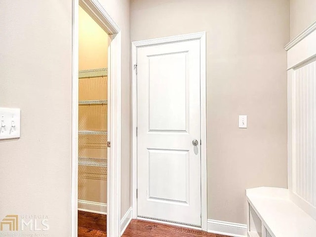 mudroom featuring baseboards and wood finished floors