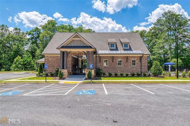 view of property with uncovered parking and fence