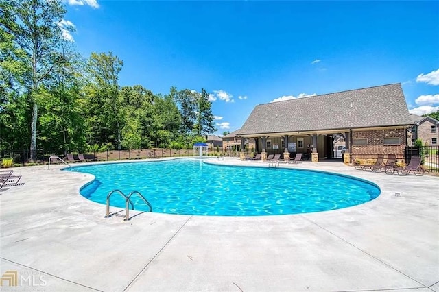 pool with fence and a patio