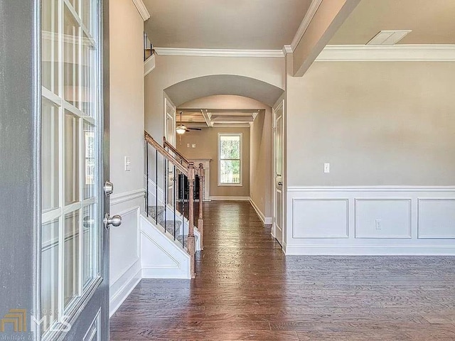 entryway with arched walkways, visible vents, stairway, dark wood-style floors, and crown molding