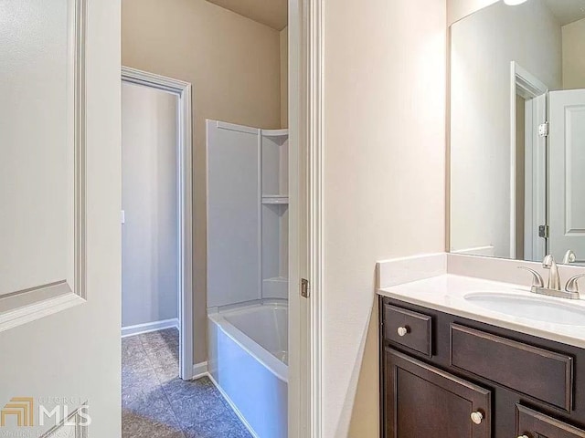 bathroom featuring shower / tub combination, baseboards, and vanity