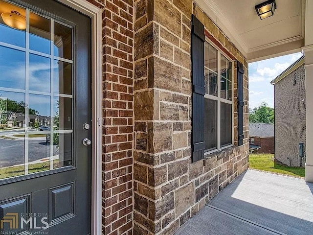 doorway to property featuring brick siding