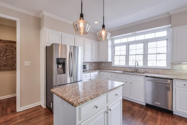 kitchen with ornamental molding, a wealth of natural light, decorative backsplash, stainless steel appliances, and a sink