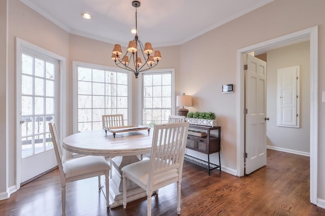 dining area featuring wood finished floors, baseboards, an inviting chandelier, recessed lighting, and ornamental molding