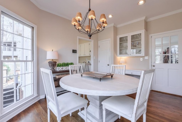 dining area with a chandelier, recessed lighting, dark wood-type flooring, and ornamental molding