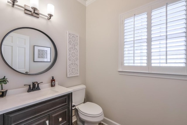 half bath with vanity, toilet, and baseboards