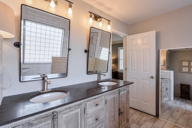 full bath with double vanity, wood finished floors, and a sink