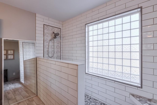 bathroom featuring a wealth of natural light and walk in shower