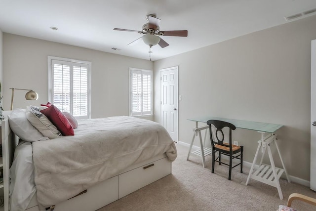 bedroom with visible vents, baseboards, ceiling fan, and carpet flooring