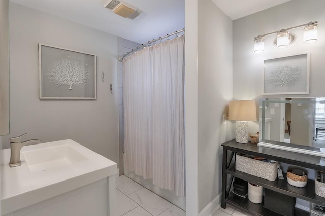 bathroom with visible vents, shower / bath combo with shower curtain, marble finish floor, baseboards, and vanity