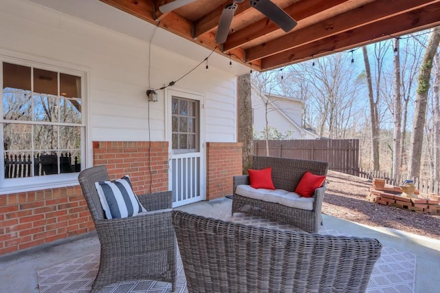 view of patio / terrace featuring outdoor lounge area and fence