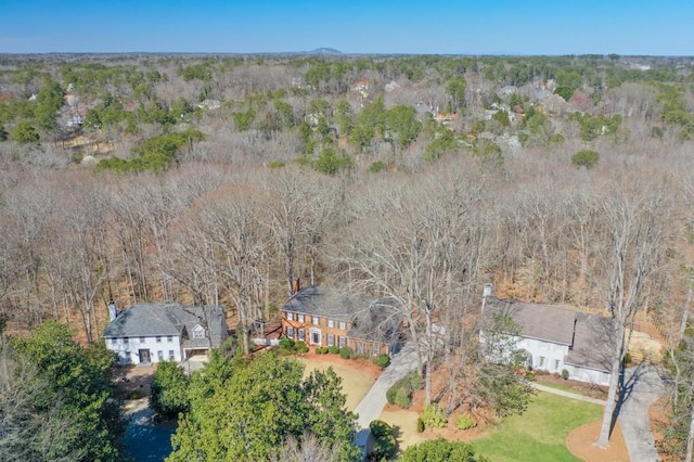 aerial view featuring a wooded view