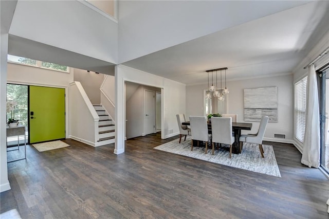945 Tiber Cir, Alpharetta, GA 30022 - dining area featuring stairway, plenty of natural light, wood finished floors, baseboards, and a towering ceiling
