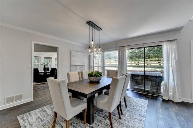 945 Tiber Cir, Alpharetta, GA 30022 - dining area featuring crown molding, baseboards, dark wood-type flooring, and a chandelier