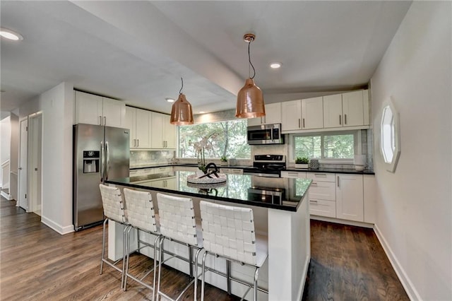945 Tiber Cir, Alpharetta, GA 30022 - kitchen with stainless steel appliances, dark countertops, decorative backsplash, white cabinets, and recessed lighting