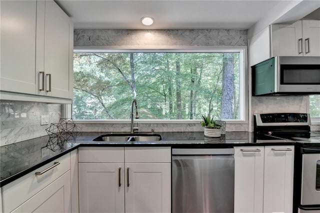 945 Tiber Cir, Alpharetta, GA 30022 - kitchen featuring appliances with stainless steel finishes, a sink, healthy amount of natural light, and decorative backsplash