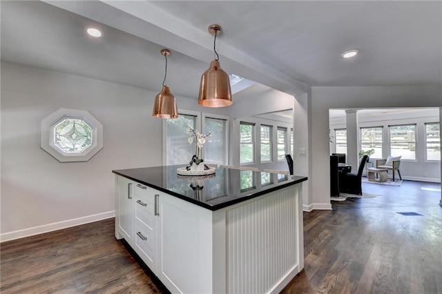 945 Tiber Cir, Alpharetta, GA 30022 - kitchen with dark countertops, baseboards, white cabinetry, dark wood-type flooring, and ornate columns